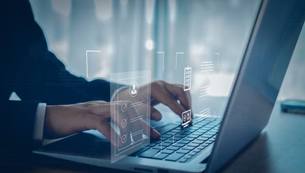 Business man doing an EDD report on laptop shutterstock_2471517921