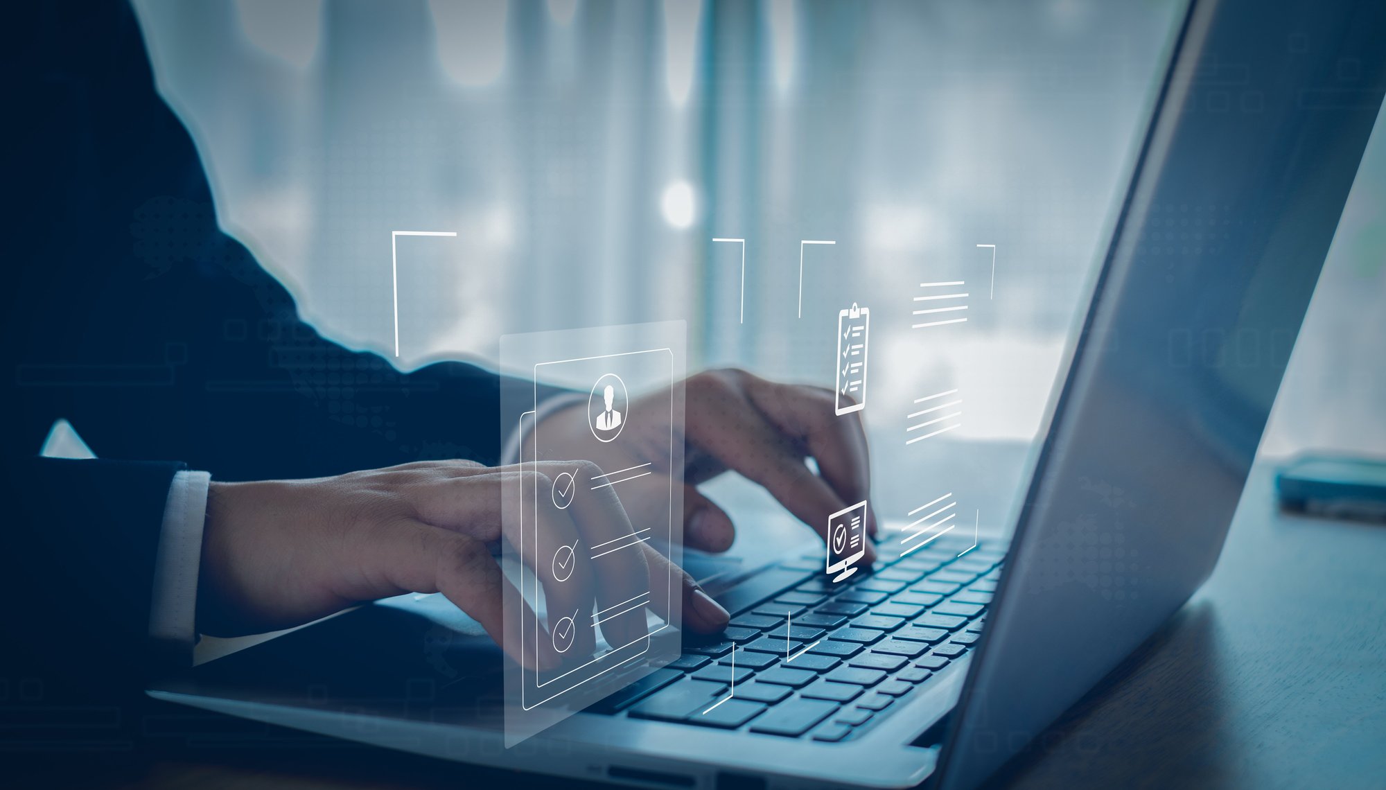 Business man doing an EDD report on laptop shutterstock_2471517921